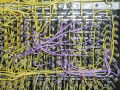 photo of 9 wire-wrap backplane slots with a tangle of yellow and purple wires
