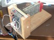 2 boards plugged into a backplane segment with many white wires and some scope probes pushed onto the wire-wrap pins