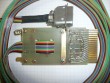 ribbon cable with compact Amphenol connector on one end and a DEC W021 circuit board on the other, solder side